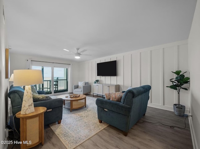 1896 New River Inlet Rd Unit 1310, North Topsail Beach, NC 28460 - living area with wood finished floors, ceiling fan, and a decorative wall