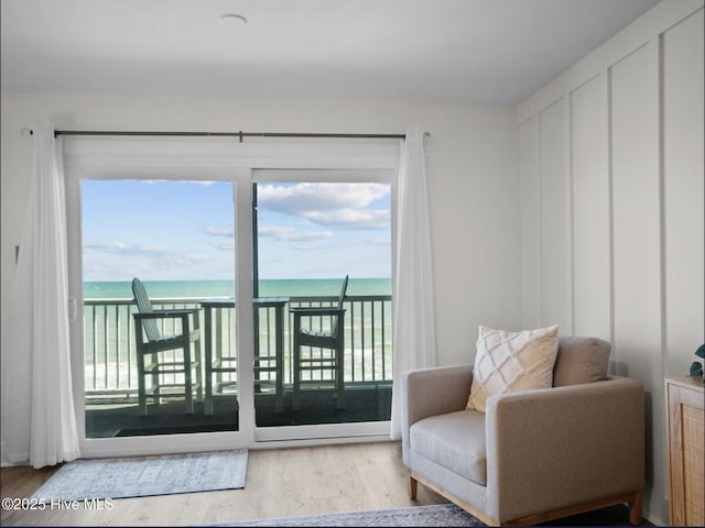 1896 New River Inlet Rd Unit 1310, North Topsail Beach, NC 28460 - living area featuring wood finished floors, healthy amount of natural light, and a water view