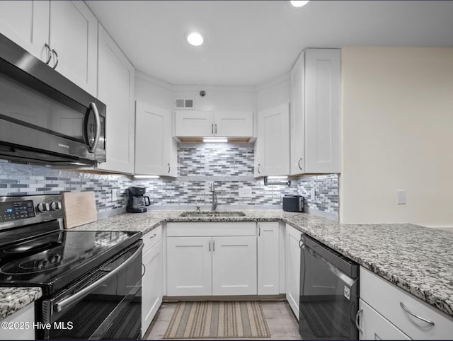 1896 New River Inlet Rd Unit 1310, North Topsail Beach, NC 28460 - kitchen with range with electric stovetop, dishwashing machine, stainless steel microwave, white cabinetry, and recessed lighting