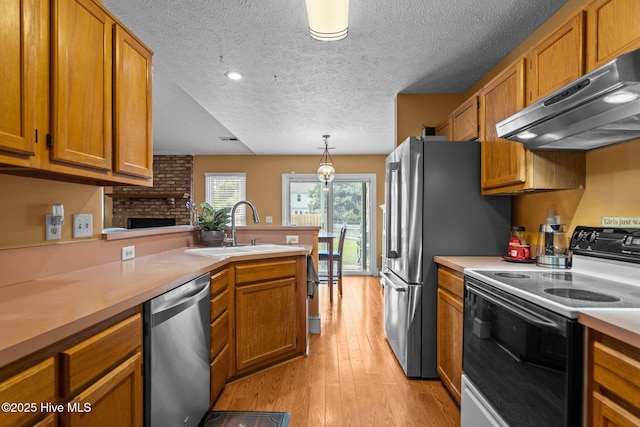 1005 Pleasant Dale Dr, Wilmington, NC 28412 - kitchen featuring white electric range, dishwasher, under cabinet range hood, a peninsula, and light countertops