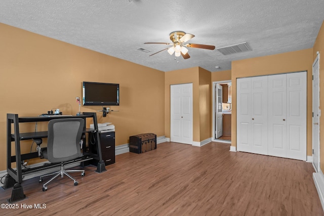 1005 Pleasant Dale Dr, Wilmington, NC 28412 - office area with wood finished floors, a ceiling fan, and a textured ceiling