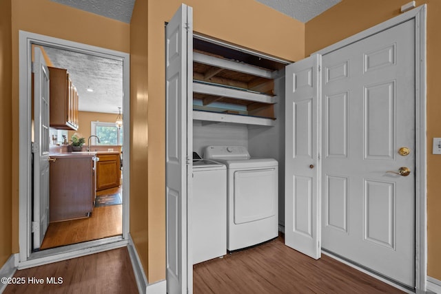 1005 Pleasant Dale Dr, Wilmington, NC 28412 - laundry area with dark wood finished floors, washer and clothes dryer, and a textured ceiling