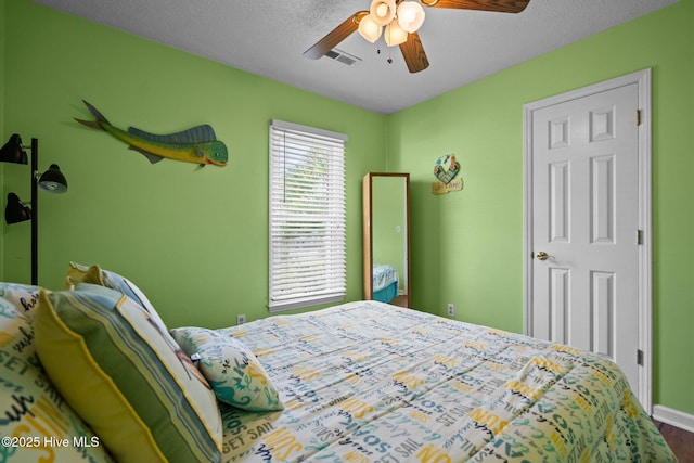 1005 Pleasant Dale Dr, Wilmington, NC 28412 - bedroom with wood finished floors, a ceiling fan, and a textured ceiling