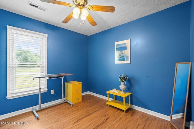 1005 Pleasant Dale Dr, Wilmington, NC 28412 - empty room featuring wood finished floors, a textured ceiling, and a ceiling fan
