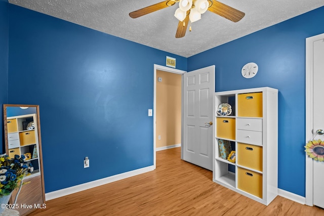 1005 Pleasant Dale Dr, Wilmington, NC 28412 - unfurnished bedroom featuring a textured ceiling, wood finished floors, and ceiling fan
