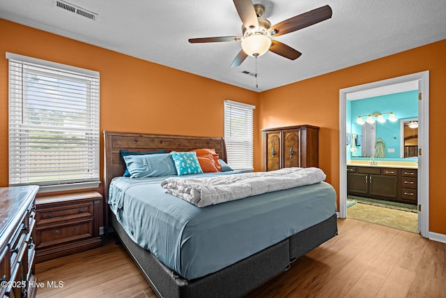 1005 Pleasant Dale Dr, Wilmington, NC 28412 - bedroom featuring light wood-style flooring, connected bathroom, and a ceiling fan