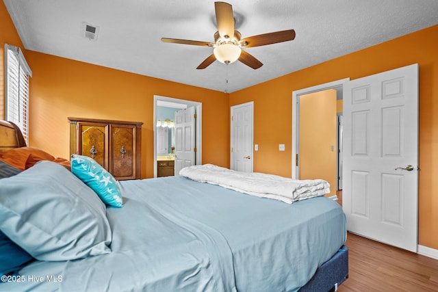 1005 Pleasant Dale Dr, Wilmington, NC 28412 - bedroom with wood finished floors, ceiling fan, and ensuite bath
