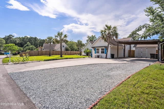 1005 Pleasant Dale Dr, Wilmington, NC 28412 - view of front of house with concrete driveway, a storage unit, and a carport