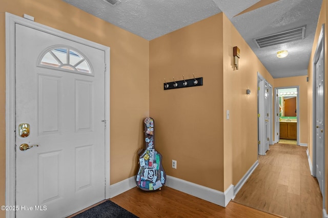 1005 Pleasant Dale Dr, Wilmington, NC 28412 - entrance foyer featuring a textured ceiling and light wood finished floors