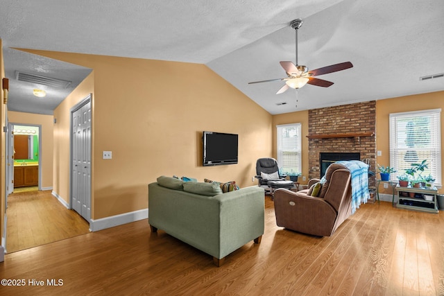 1005 Pleasant Dale Dr, Wilmington, NC 28412 - living area featuring light wood-style flooring, ceiling fan, healthy amount of natural light, a textured ceiling, and lofted ceiling
