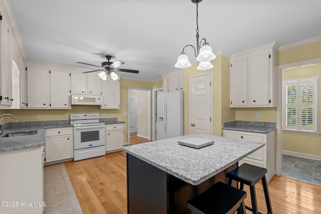 7405 Chickadee Ct, Sanford, NC 27332 - kitchen featuring white appliances, light wood-style flooring, white cabinetry, ornamental molding, and a kitchen island