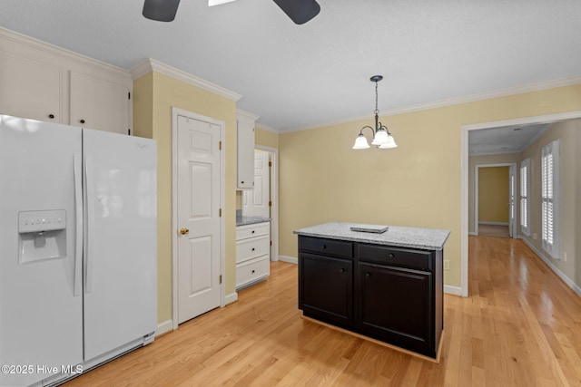 7405 Chickadee Ct, Sanford, NC 27332 - kitchen with white fridge with ice dispenser, ceiling fan, light wood-type flooring, pendant lighting, and white cabinets