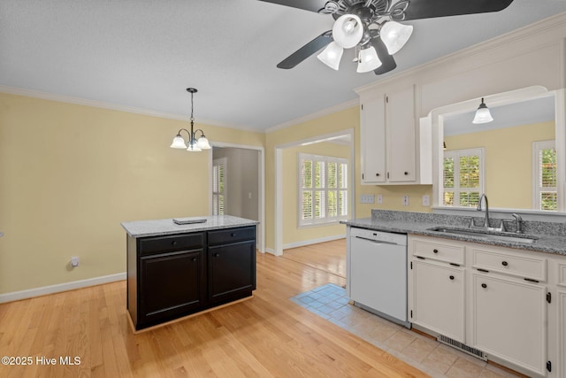 7405 Chickadee Ct, Sanford, NC 27332 - kitchen featuring white dishwasher, light wood-style flooring, white cabinetry, crown molding, and hanging light fixtures