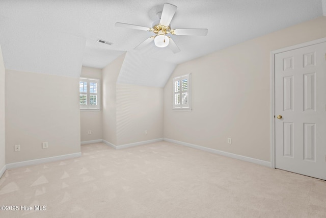7405 Chickadee Ct, Sanford, NC 27332 - bonus room featuring plenty of natural light, lofted ceiling, ceiling fan, and light colored carpet