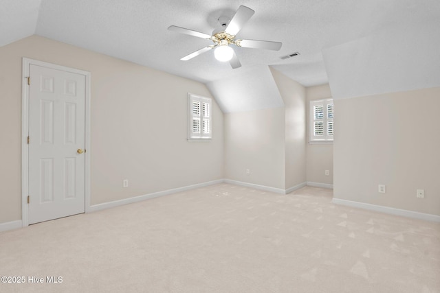7405 Chickadee Ct, Sanford, NC 27332 - bonus room featuring lofted ceiling, plenty of natural light, light carpet, and a ceiling fan