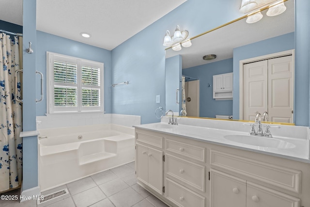 7405 Chickadee Ct, Sanford, NC 27332 - full bath with tile patterned floors, a garden tub, double vanity, a shower with shower curtain, and a textured ceiling