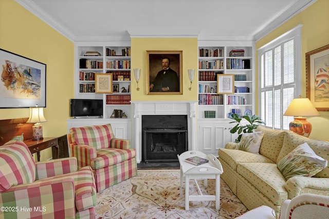 415 S 3rd St, Wilmington, NC 28401 - living area with built in shelves, a fireplace with flush hearth, and ornamental molding