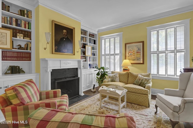 415 S 3rd St, Wilmington, NC 28401 - living room featuring built in features, a fireplace with flush hearth, wood finished floors, and ornamental molding