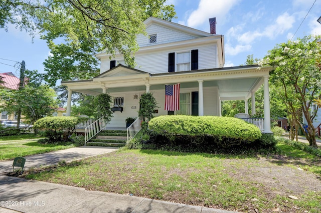 415 S 3rd St, Wilmington, NC 28401 - view of front facade featuring covered porch, a chimney, and a front lawn