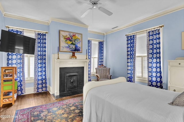 415 S 3rd St, Wilmington, NC 28401 - bedroom with multiple windows, wood finished floors, crown molding, a fireplace, and a ceiling fan