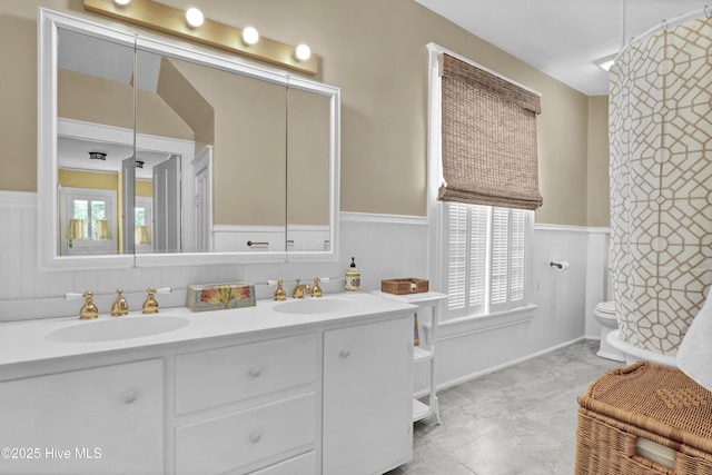 415 S 3rd St, Wilmington, NC 28401 - full bathroom with a wainscoted wall and double vanity