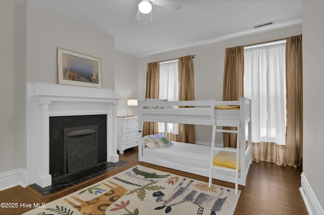 415 S 3rd St, Wilmington, NC 28401 - bedroom with wood finished floors, a fireplace with flush hearth, and ceiling fan