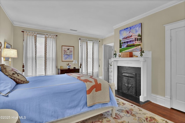 415 S 3rd St, Wilmington, NC 28401 - bedroom featuring crown molding, wood finished floors, and a fireplace