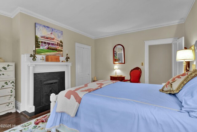 415 S 3rd St, Wilmington, NC 28401 - bedroom with crown molding, wood finished floors, and a fireplace