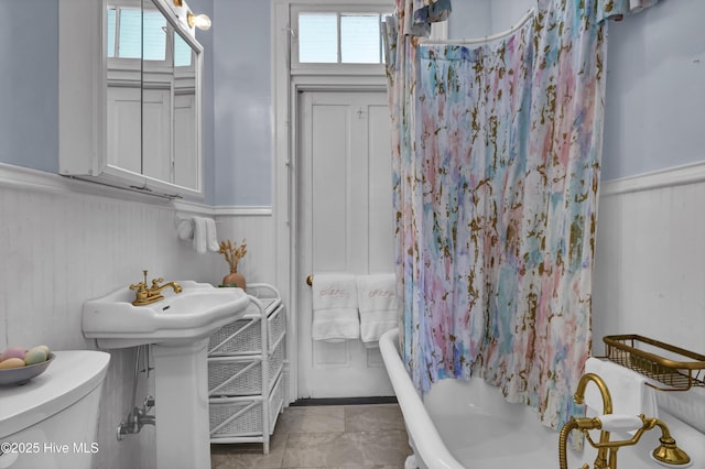 415 S 3rd St, Wilmington, NC 28401 - bathroom featuring a wainscoted wall and shower / bathtub combination with curtain