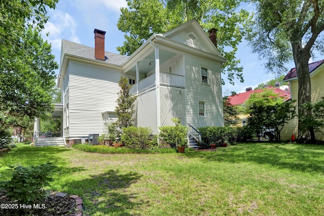 415 S 3rd St, Wilmington, NC 28401 - rear view of house featuring a chimney, a lawn, and a balcony