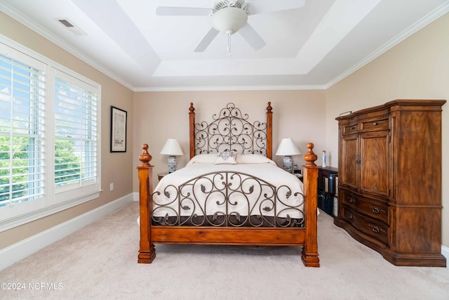 300 Midyette St Unit A15, Oriental, NC 28571 - bedroom with light colored carpet, multiple windows, a raised ceiling, and a ceiling fan