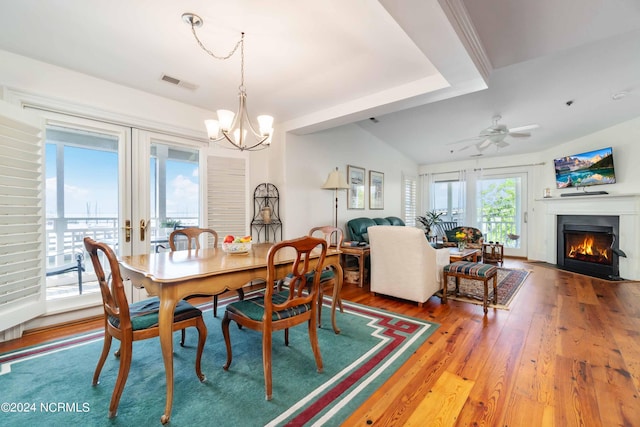 300 Midyette St Unit A15, Oriental, NC 28571 - dining room with a chandelier, wood finished floors, a lit fireplace, and a ceiling fan