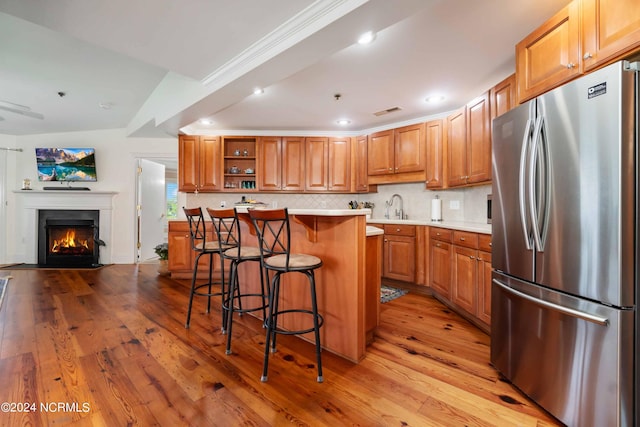300 Midyette St Unit A15, Oriental, NC 28571 - kitchen with freestanding refrigerator, a breakfast bar area, open shelves, light wood-style flooring, and recessed lighting