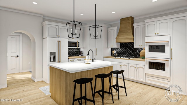 243 W Winding Way, Wallace, NC 28466 - kitchen featuring premium range hood, paneled refrigerator, stainless steel gas stovetop, ornamental molding, and recessed lighting
