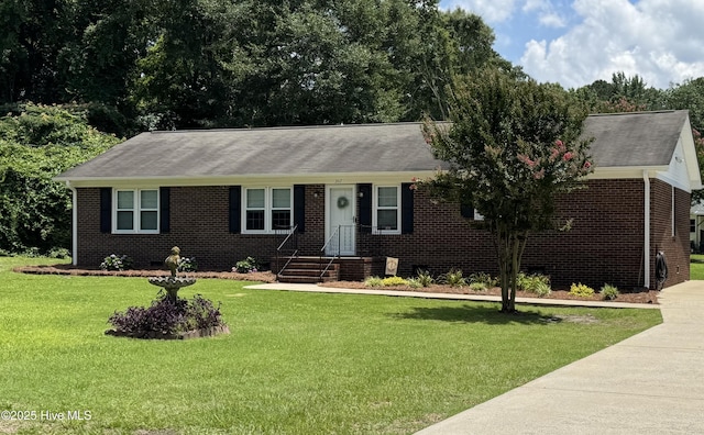 347 Forest Knolls Rd, Goldsboro, NC 27534 - ranch-style house with brick siding, a front yard, and roof with shingles