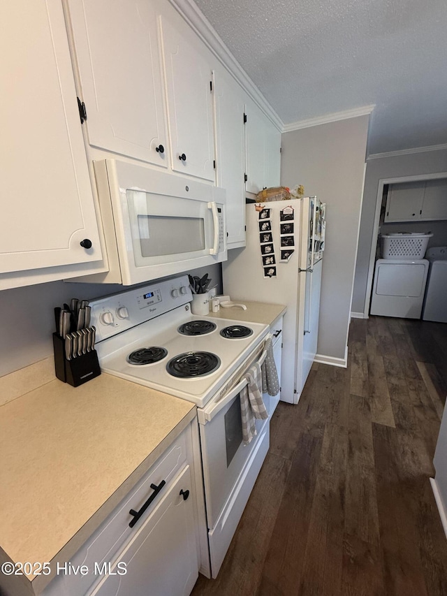 347 Forest Knolls Rd, Goldsboro, NC 27534 - kitchen featuring white appliances, washer and dryer, dark wood-type flooring, white cabinetry, and light countertops