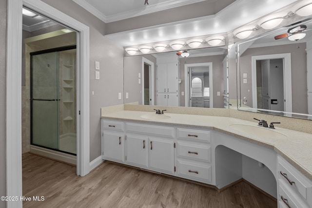 212 Evanswood Dr, Greenville, NC 27858 - bathroom featuring double vanity, ornamental molding, a stall shower, and wood finished floors