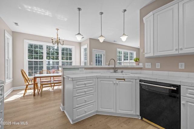 324 Foster Creek Rd, Swansboro, NC 28584 - kitchen with dishwasher, a peninsula, white cabinets, and light wood-style flooring