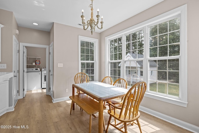 324 Foster Creek Rd, Swansboro, NC 28584 - dining room featuring a chandelier, light wood-style flooring, separate washer and dryer, and plenty of natural light