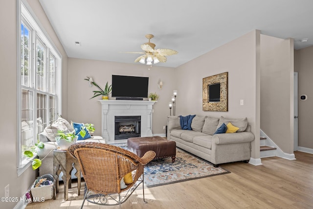 324 Foster Creek Rd, Swansboro, NC 28584 - living room featuring wood finished floors, a fireplace, and a ceiling fan