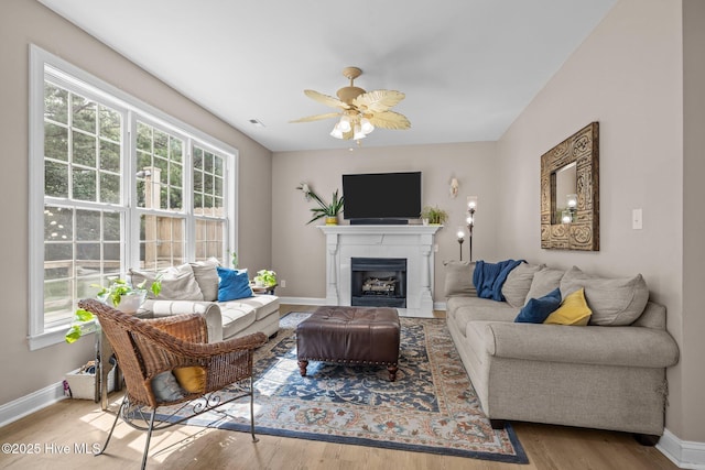 324 Foster Creek Rd, Swansboro, NC 28584 - living area with healthy amount of natural light, wood finished floors, a ceiling fan, and a tile fireplace