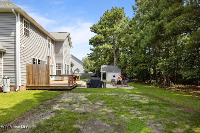 324 Foster Creek Rd, Swansboro, NC 28584 - view of grassy yard featuring a deck, a patio, and a storage shed
