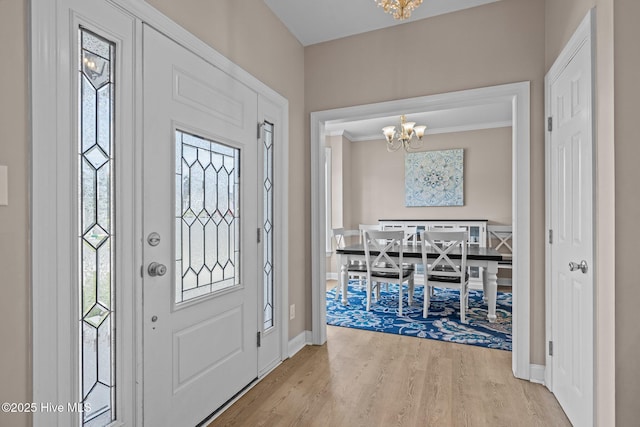324 Foster Creek Rd, Swansboro, NC 28584 - entryway featuring a chandelier, light wood-type flooring, and crown molding