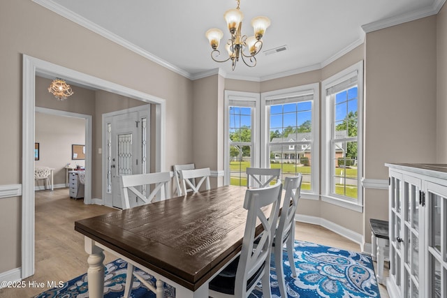 324 Foster Creek Rd, Swansboro, NC 28584 - dining space featuring a chandelier, light wood-style flooring, and ornamental molding
