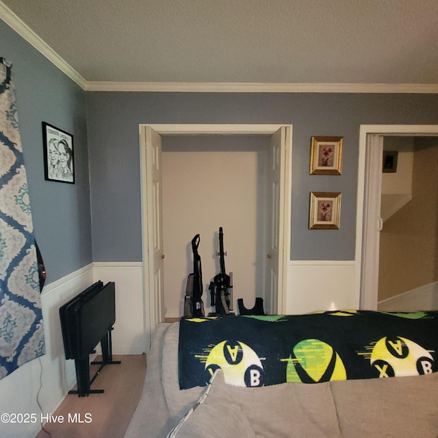 204 Tyree Rd, Kinston, NC 28504 - carpeted bedroom with crown molding, a textured ceiling, and wainscoting