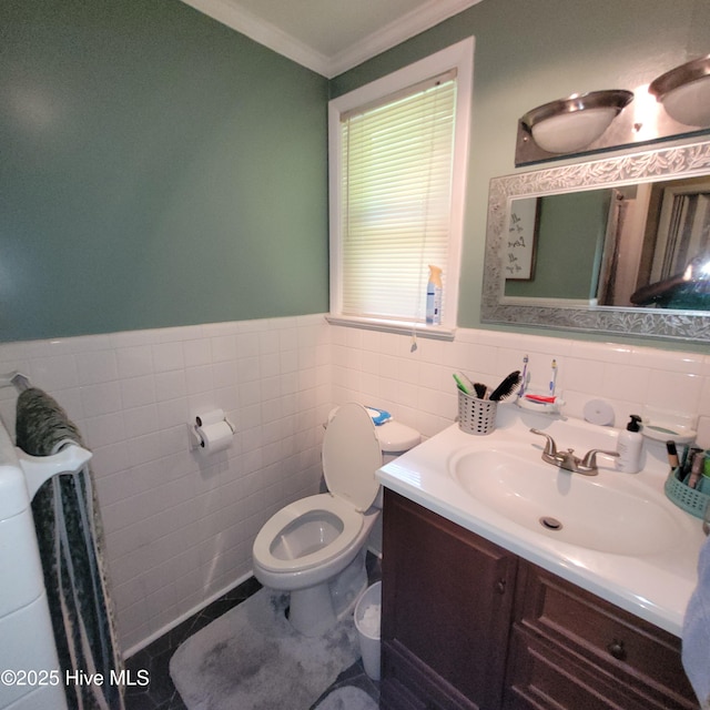 204 Tyree Rd, Kinston, NC 28504 - half bathroom with tile walls, vanity, crown molding, a wainscoted wall, and tile patterned floors
