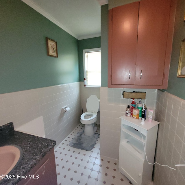 204 Tyree Rd, Kinston, NC 28504 - bathroom with tile walls, a wainscoted wall, vanity, crown molding, and tile patterned floors