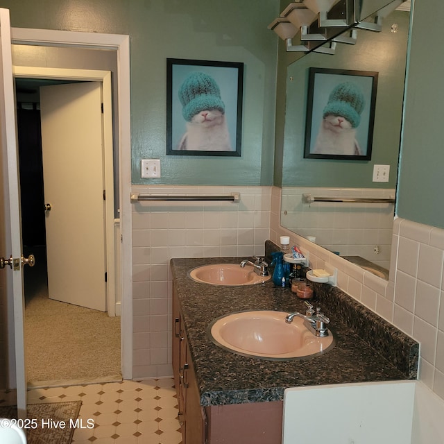 204 Tyree Rd, Kinston, NC 28504 - bathroom with double vanity, tile walls, and a wainscoted wall