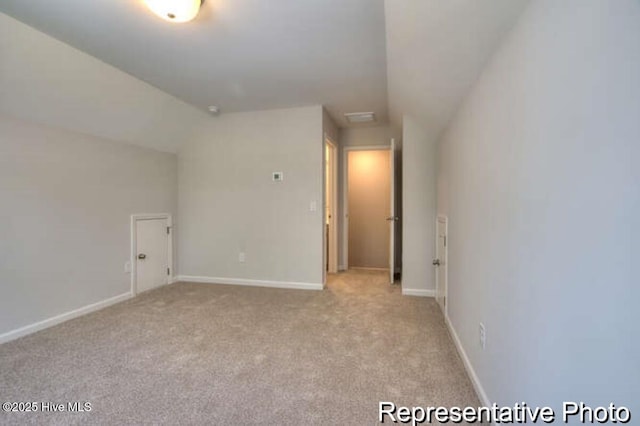 120 Forest Walk SW Unit 73, Sunset Beach, NC 28468 - unfurnished room featuring light colored carpet and lofted ceiling