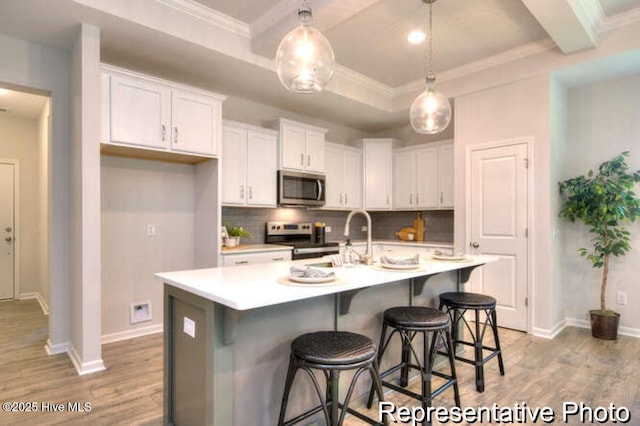 120 Forest Walk SW Unit 73, Sunset Beach, NC 28468 - kitchen with stainless steel appliances, light wood finished floors, tasteful backsplash, white cabinets, and ornamental molding